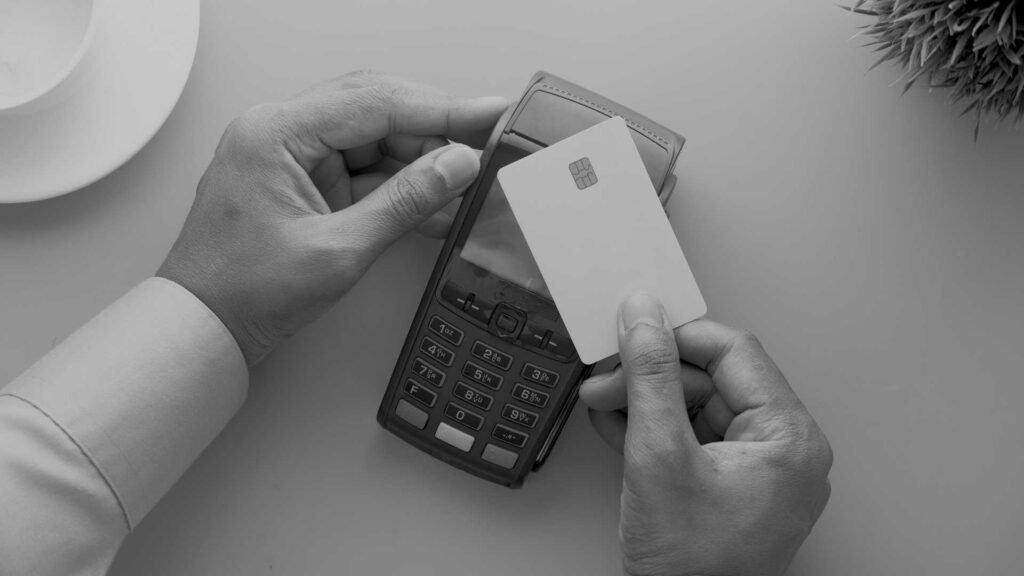 Image of someone paying with a card